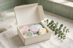Pastel shower steamer tablets in an open box