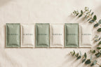 NURTURA-branded bath soak sachets in sage and ivory pouches