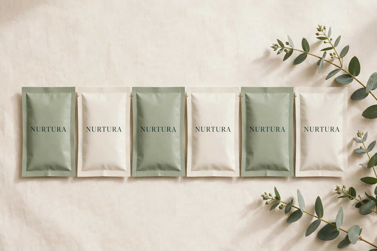 NURTURA-branded bath soak sachets in sage and ivory pouches
