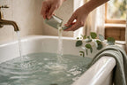 Pouring bath soak salts from a sachet into a running bath