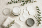 Flat lay of Nurtura toner pads jar with loose pads towel and eucalyptus